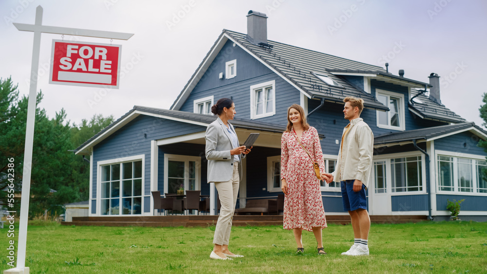 REALTOR® showing a beautiful Edmonton home to smiling buyers