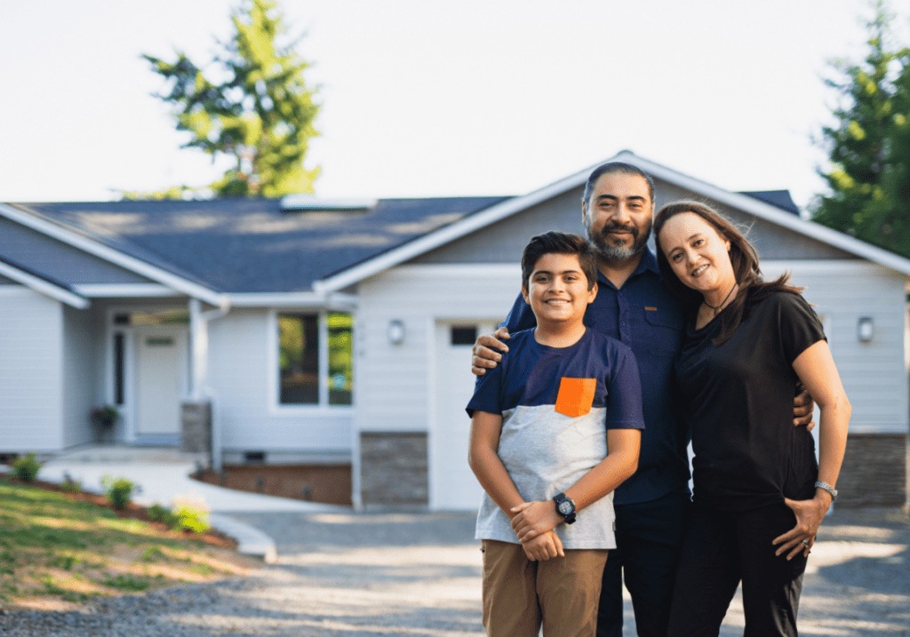 Family standing in front of their Edmonton home with their REALTOR®